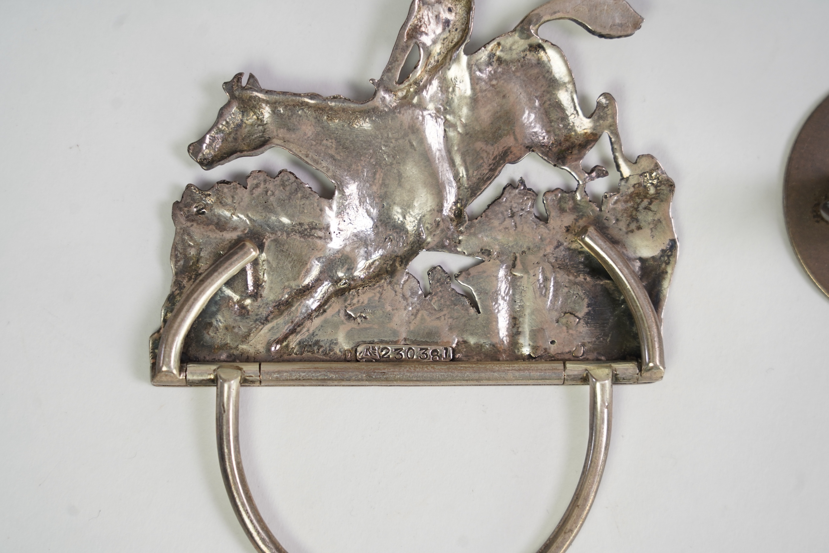 A pair of late Victorian silver menu holders, each modelled as a horse and rider leaping a fence, by Samuel Jacob, London 1894/5, height 66mm, together with a pair of Edwardian silver and enamel menu holders, each decora
